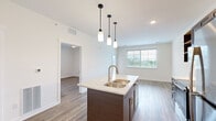 Step into a world of refined living in this exquisite 590 square foot home. The moment you enter, you'll be captivated by the seamless blend of style and functionality. The heart of this home is the gourmet kitchen, a culinary enthusiast's dream come true. Sleek dark wood cabinetry contrasts beautifully with gleaming stainless steel appliances, while the granite countertops and stylish pendant lighting add a touch of luxury. The spacious island isn't just perfect for meal prep; it's an ideal spot for casual dining or entertaining friends.

The 140 square foot primary bedroom is a serene sanctuary, boasting ample natural light and a generous walk-in closet with custom shelving to keep your wardrobe impeccably organized. With two well-appointed bathrooms, this home offers convenience and privacy rarely found in spaces of this size.

Throughout the home, warm wood-look flooring creates a cohesive and inviting atmosphere, while large windows flood the space with natural light, making it feel open and airy. The thoughtful layout maximizes every inch, proving that luxury isn't about size, but smart design.

Located in the desirable Kalamazoo area, this home at 5141 N Wagon Trl is your gateway to a life of comfort and style. Whether you're a young professional, a downsizing couple, or anyone in between, this property offers the perfect blend of modern amenities and cozy charm. Don't just imagine the possibilities – make this your reality and start living the life you've always dreamed of.