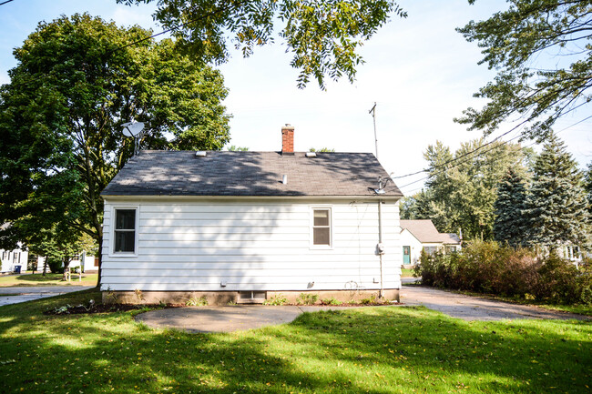 Back of house with patio and new landscaping - 176 E 35th St