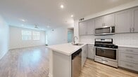 Located at 3000 Van Buren Blvd in Riverside, CA, this well-appointed 1-bedroom, 1-bathroom residence offers a thoughtfully designed single-floor layout with modern finishes throughout. The open-concept kitchen and living area serves as the heart of the home, featuring light wood-style flooring, recessed lighting, and a ceiling fan that enhances the bright, airy atmosphere. The kitchen is outfitted with gray shaker-style cabinetry, a classic white subway tile backsplash, a peninsula island with a white quartz countertop and undermount sink, and a full suite of stainless steel appliances including a gas range, over-the-range microwave, dishwasher, and refrigerator. Natural light flows into the living area through multiple windows. The bedroom offers plush carpeting, a ceiling fan, and windows with blinds that allow adjustable natural light. The bathroom is clean and contemporary, showcasing gray cabinetry, a white quartz vanity countertop, a tub-shower combination with tile surround, and wood-style flooring. A dedicated closet and hallway round out the functional layout, making efficient use of the available space throughout this move-in-ready residence.