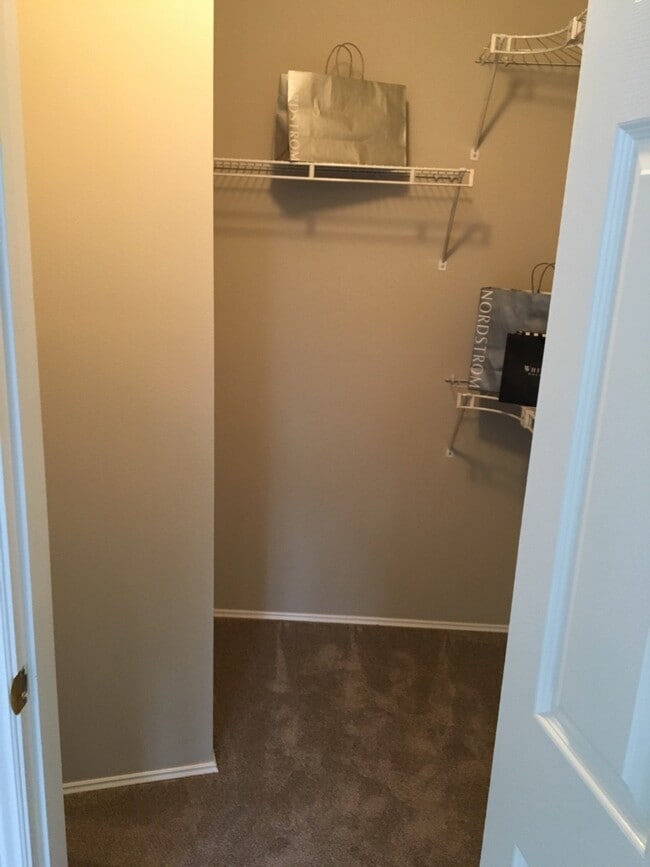 walk-in closet in master bedroom. - 9915 NE 124th St