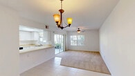 Located at 4616 SW 8th Pl in Cape Coral, Florida, this single-floor, 3-bedroom, 2-bathroom home offers a practical and comfortable layout throughout. The entrance leads into a combined dining and living area that is bright and open, featuring a mix of tile and carpet flooring. An elegant chandelier anchors the dining space, while a ceiling fan provides comfort in the carpeted living area. Sliding glass doors invite natural light and provide outdoor access from both the living area and the primary bedroom.

The kitchen is well-appointed with white cabinetry, ample counter space, a double sink, a full-size refrigerator, and a range. A peninsula counter adds additional prep space, and a pantry provides extra storage. Recessed lighting and a tray ceiling give the kitchen a clean, polished look.

The primary bedroom is generously sized, featuring a ceiling fan, sliding glass door access to the outdoors, and a large closet. A second bedroom stands out with a painted concrete floor and dual closets. The two bathrooms are clean and functional, each with tile flooring, vanities with countertops, and a tub-shower combination. Five closets throughout the home ensure excellent storage capacity.

Outside, the property is framed by lush tropical vegetation, including banana plants, within a well-maintained community setting.