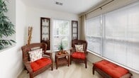 Located at 2309 Providence Pointe Ln in Winston-Salem, NC, this single-floor residence offers a thoughtfully designed layout that balances comfort and functionality. The open floor plan connects key living areas, creating a cohesive and inviting atmosphere throughout.

The sunlit sunroom is a standout feature, boasting a wall of large windows with blinds and drapes that allow for abundant natural light and outdoor views, making it an ideal relaxing retreat. Adjacent to this is a dedicated dining area with carpet flooring, providing a welcoming space for meals.

The kitchen features warm-toned wood cabinetry, tile flooring, light countertops, and full appliances including a refrigerator and dishwasher. A doorway from the kitchen leads directly into a dedicated laundry room, which accommodates a full-sized washer and dryer along with overhead wire shelving for storage convenience.

Two well-proportioned bedrooms offer plush carpet flooring and ceiling fans with light fixtures. Each room features windows that bring in natural light. The bathroom includes a single-sink vanity with wood cabinetry, a large mirror, tile flooring, and a full tub-shower combination. The overall aesthetic of the home is clean and neutral, with light walls throughout that lend an airy, welcoming ambiance to every room.