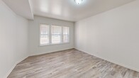 This 670 square foot apartment in Chicago offers a thoughtfully designed living space with two bedrooms and one bathroom. The single-floor layout maximizes functionality within its compact footprint. Upon entering, you're greeted by a cohesive design aesthetic featuring wood-look flooring that flows seamlessly throughout the apartment, creating a sense of continuity and warmth.

The living room serves as the heart of the home, boasting multiple windows that flood the space with natural light. The primary bedroom, measuring 130 square feet, provides a comfortable retreat with ample room for a bed and essential furnishings. Both bedrooms feature crisp white walls and wood-look flooring, creating a clean and inviting atmosphere.

The kitchen showcases a modern design with light blue cabinetry, contrasting beautifully against white countertops. Under-cabinet lighting adds a warm glow, while stainless steel appliances, including a gas range, offer both style and functionality. The bathroom, though compact, is efficiently designed with a single vanity, medicine cabinet, and modern fixtures.

Throughout the apartment, white walls and trim work create a bright, airy feel, amplifying the natural light from the numerous windows. The overall design aesthetic is clean and contemporary, appealing to those who appreciate minimalist, low-maintenance living spaces.