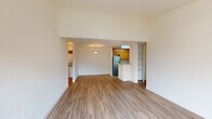 Located at 1840 Almaden Rd in San Jose, California, this single-floor residence offers a clean, functional layout designed for comfortable everyday living. The open living and dining area is finished with warm-toned wood-look flooring that extends throughout the main spaces, creating a cohesive and inviting atmosphere. Elevated ceilings in the living area add a sense of openness, while a pendant light fixture provides a focal point overhead.

The kitchen is efficiently arranged in a galley-style configuration, featuring warm wood cabinetry, light stone-finish countertops, and a full suite of stainless steel appliances including a refrigerator, electric range, and dishwasher. A built-in peninsula with counter seating connects the kitchen to the living area, promoting an open flow between spaces.

The bedroom is carpeted for comfort and benefits from multiple windows that invite natural light and views of the surrounding greenery. A built-in shelving closet provides organized storage directly accessible from the room.

The bathrooms are finished with wood-look flooring, warm wood vanity cabinetry, and full soaking tub and shower combinations. Additional storage is available through built-in shelving units integrated into the hallway areas, maximizing the practical use of space throughout the home.