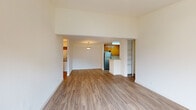Located at 1840 Almaden Rd in San Jose, California, this single-floor residence offers a clean, functional layout designed for comfortable everyday living. The open living and dining area is finished with warm-toned wood-look flooring that extends throughout the main spaces, creating a cohesive and inviting atmosphere. Elevated ceilings in the living area add a sense of openness, while a pendant light fixture provides a focal point overhead.

The kitchen is efficiently arranged in a galley-style configuration, featuring warm wood cabinetry, light stone-finish countertops, and a full suite of stainless steel appliances including a refrigerator, electric range, and dishwasher. A built-in peninsula with counter seating connects the kitchen to the living area, promoting an open flow between spaces.

The bedroom is carpeted for comfort and benefits from multiple windows that invite natural light and views of the surrounding greenery. A built-in shelving closet provides organized storage directly accessible from the room.

The bathrooms are finished with wood-look flooring, warm wood vanity cabinetry, and full soaking tub and shower combinations. Additional storage is available through built-in shelving units integrated into the hallway areas, maximizing the practical use of space throughout the home.