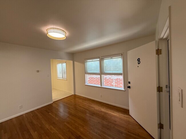 Living room: real hardwood floors, overhead rattan lamp on dimmer - 247 5th St
