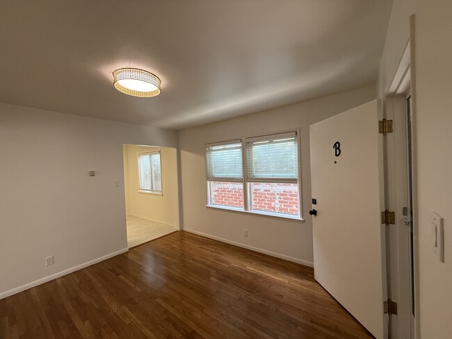 Living room: real hardwood floors, overhead rattan lamp on dimmer - 247 5th St