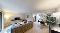 Located at 6715 Lake Shore Dr in Westmont, IL, this two-bedroom, one-bathroom home offers a well-organized single-floor layout designed for comfortable everyday living. The living room is a bright, inviting space featuring light wood-style flooring, a sliding glass door that opens to a view of lush greenery, and a ceiling-mounted air conditioning unit. The open flow connects seamlessly to the dining area, which features a ceiling fan, light wood flooring, and a clean, modern aesthetic with neutral walls. The kitchen is efficiently designed with white cabinetry, granite-style countertops, a double basin sink, and a full suite of stainless steel appliances including a gas range and refrigerator. The primary bedroom is a generously sized retreat with plush carpeting, a ceiling fan, natural light from a window, and ample room for a seating area. The second bedroom is similarly carpeted and well-lit, offering a comfortable and versatile space. The bathroom features a clean, all-white design with a tub-shower combo, a single vanity with white cabinetry, and light wood-style flooring. Throughout the home, a neutral color palette and consistent finishes create a cohesive, move-in-ready atmosphere.