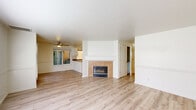 Located at 339 SE Reed Market Rd in Bend, Oregon, this single-story, 3-bedroom, 2-bathroom home offers a practical and comfortable layout with consistent light wood laminate flooring throughout. The open living room serves as the heart of the home, featuring a ceiling fan and a tile-surround fireplace with a white mantel that anchors the space. An adjacent dining area flows naturally into the kitchen, which is outfitted with white shaker-style cabinetry, granite-look countertops, a double basin sink, and a full suite of stainless steel appliances including a refrigerator, range, and over-the-range microwave. The three bedrooms are bright and cleanly finished with white walls and offer ample room for furnishings. The primary bedroom includes access to a hallway leading to a bathroom with a warm wood vanity. Both bathrooms feature tub-shower combinations with white tile surrounds. Several rooms include large windows that invite natural light and views of the surrounding exterior. The home's clean, neutral palette and cohesive flooring create a move-in-ready feel throughout this efficiently designed Bend residence.