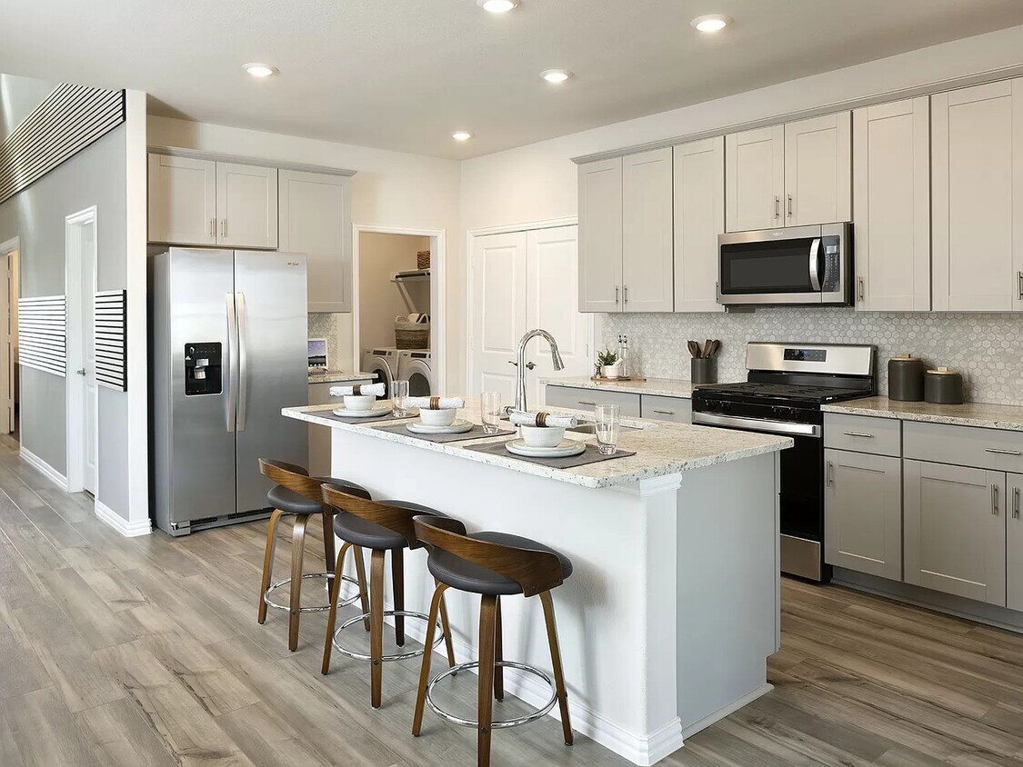 Enjoy having company sit at the island while you cook. - 1509 Wind Springs Dr