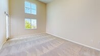 Located at 431 El Camino Real in Santa Clara, CA, this well-appointed 1-bedroom, 1-bathroom residence offers a thoughtfully designed single-floor layout. The combined kitchen and living area serves as the heart of the home, featuring rich wood cabinetry, granite countertops, stainless steel appliances including a refrigerator, range, and over-the-range microwave, and durable hardwood-style flooring. A granite-topped breakfast bar with pendant lighting provides a seamless transition into the carpeted living area, which boasts impressively soaring ceilings and stacked windows that flood the space with natural light. The bedroom is comfortably sized, finished with plush carpet, a window with outdoor greenery views, and convenient closet access. The bathroom is well-equipped with an extended white vanity, generous counter space, dual mirrors, and tile flooring, offering a clean and functional design. A hallway connects the rooms efficiently. Throughout the residence, warm neutral tones, recessed lighting, and consistent finishes create a cohesive and inviting ambiance suited for comfortable everyday living in the heart of Silicon Valley.