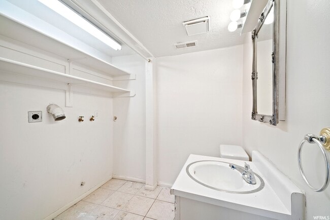 Downstairs half bath and laundry - 7104 S Terrell Cir