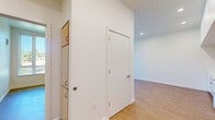 Located at 3097 SE Meek St in Milwaukie, Oregon, this 2-bedroom, 1-bathroom unit offers a clean, modern design across a single floor. Warm hardwood-style flooring flows consistently throughout the main living areas and bedrooms, creating a cohesive and inviting atmosphere. The open living and kitchen area features high ceilings with recessed lighting, light wood cabinetry, and white appliances, providing a functional and bright space for everyday living. A connecting hallway links the main living area to the private quarters. Both bedrooms are well-sized, with large windows dressed in vertical blinds that invite generous natural light and offer outdoor views of the surrounding Milwaukie neighborhood. The primary bedroom includes a spacious built-in closet with sleek sliding doors, providing ample storage. The second bedroom also benefits from natural light through its own window. The bathroom is thoughtfully designed with accessibility in mind, featuring grab bars, a light wood vanity with drawers, and neutral-toned flooring. Throughout the unit, crisp white walls and clean lines give the space a fresh, move-in-ready feel suited to a variety of lifestyles.