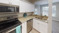 Located at 811 Polo Rd in Columbia, SC, this single-floor residence offers a well-designed layout with a thoughtful blend of comfort and functionality. The kitchen is a standout feature, showcasing crisp white shaker cabinetry, granite countertops, stainless steel appliances including a range, microwave, and dishwasher, and light wood-style flooring that extends throughout the common areas. Multiple windows allow natural light to pour in, creating a bright and welcoming atmosphere.

The bedrooms are generously sized, each featuring plush carpet, ceiling fans, and large windows with blinds that frame views of the surrounding greenery. At least one bedroom includes a walk-in closet, providing ample storage. The neutral wall tones throughout the home lend a clean, versatile aesthetic.

The bathrooms are well-appointed, with white vanity cabinetry and tub-shower combinations. One bathroom features wood-look vinyl flooring and a long vanity countertop, while another offers a similarly clean and functional design. The overall layout, visible in the dollhouse view, flows efficiently across the single floor, connecting living, sleeping, and utility spaces in a practical and comfortable arrangement.
