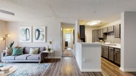 This thoughtfully designed 2-bedroom, 2-bathroom residence offers a comfortable and functional single-floor layout. The open-concept living and dining area is a welcoming focal point, featuring durable wood-look flooring, a ceiling fan, and a large sliding glass door that fills the space with natural light. The galley-style kitchen is well-equipped with gray shaker cabinetry, marble-look countertops, a tiled backsplash, stainless steel appliances, and ample storage throughout. A peninsula counter connects the kitchen to the main living area, enhancing the open flow.

A central hallway leads to both bedrooms, each featuring plush carpeting, ceiling fans, and windows that bring in natural light and outdoor views. The primary bedroom is generously sized with its own dedicated closet. The second bedroom is equally comfortable, offering similar finishes and natural brightness.

Both bathrooms are finished with gray vanity cabinetry, marble-look countertops, and wood-look flooring. One bathroom features a full tub-shower combination with white subway tile surround, while the other offers a refined vanity with a large mirror and contemporary lighting. Two closets provide practical storage throughout the residence, completing this well-balanced and move-in-ready home.