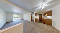 This single-floor, 2-bedroom, 1-bathroom home in Temperance, MI offers a well-organized and functional layout. The galley-style kitchen is lined with warm oak cabinetry on both sides, providing ample storage, and is equipped with a white electric range, refrigerator, and a double sink with under-cabinet lighting. Stone-look tile flooring runs through the kitchen and connects seamlessly to the adjoining living area. The open living room is generously sized, featuring neutral carpet and clean white walls that create a bright, versatile space. Both bedrooms are carpeted and filled with natural light from windows overlooking the outdoors. The primary bedroom is comfortably sized and includes a dedicated walk-in closet with built-in shelving. The full bathroom features a tub-shower combo with a clean white surround and stone-look tile flooring that complements the kitchen. A dedicated laundry room offers washer hookups, upper cabinetry, wire shelving, and tile flooring, providing excellent utility and storage. Throughout the home, warm wood-toned doors and trim add a cohesive, classic character against the neutral walls and carpeting.