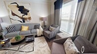 Located at 2000 Broadstone Way in Apex, NC, this thoughtfully designed single-floor residence offers a cohesive blend of modern style and everyday comfort. The open-concept living area serves as the heart of the home, showcasing rich hardwood-style flooring, crown molding, and generous natural light streaming through large windows dressed with elegant draping. The space flows seamlessly into a separate dining area, making it well-suited for both relaxed living and entertaining.

The kitchen is outfitted with dark espresso cabinetry, granite-style countertops, and a full suite of stainless steel appliances. A breakfast bar provides additional seating and connects the kitchen to the adjacent living and dining spaces.

The bedrooms offer a calm retreat, featuring plush carpeting, ample natural light, and ceiling fixtures. The primary bedroom is generously proportioned and includes windows that invite in soft daylight.

The bathroom features a dark wood vanity with a granite-style countertop, a large mirror, and tile flooring, combining functionality with a clean, polished aesthetic.

Throughout the residence, a neutral color palette and consistent design details create a warm, inviting ambiance that is both sophisticated and livable.