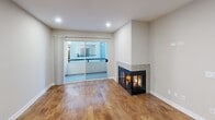 This 670 square foot apartment in West Hollywood offers a thoughtfully designed living space with two bedrooms and two bathrooms. The open-concept layout features a combined kitchen and living area, creating a sense of spaciousness despite the compact footprint. The kitchen boasts modern appliances, including a stainless steel refrigerator, and sleek cabinetry with a mix of wood tones and glass-front uppers. Granite countertops and a tiled backsplash add a touch of elegance.

The living room is anchored by a contemporary corner fireplace, perfect for cozy evenings. Large sliding glass doors lead to an outdoor space, allowing natural light to flood the interior. Hardwood floors run throughout, unifying the space and adding warmth.

Both bedrooms feature ample closet space with sliding mirrored doors, maximizing storage and visually expanding the rooms. The bathrooms are designed with functionality in mind, incorporating modern fixtures and finishes. The hallway provides additional storage solutions, enhancing the apartment's overall efficiency.

Located at 1274 North Crescent Heights Blvd., this apartment combines style and practicality in a prime West Hollywood location, offering a comfortable urban living experience within its efficient 670 square foot layout.