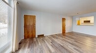 Located at 4493 S Buffalo St in Orchard Park, NY, this 2-bedroom, 2-bathroom single-floor residence offers a clean, modern living environment with thoughtful updates throughout. The open-concept living room and kitchen area serves as the heart of the home, featuring light wood-tone luxury vinyl plank flooring that extends seamlessly across the main living spaces, creating a bright and cohesive feel. Neutral light-gray walls provide a versatile backdrop throughout.

The kitchen is well-appointed with white shaker-style cabinetry, granite countertops, a classic white subway tile backsplash, and a full suite of stainless steel appliances including a range, microwave, dishwasher, and refrigerator. A window above the sink allows natural light to fill the space. The kitchen connects to the living area via a pass-through, enhancing the open flow of the layout.

The primary bedroom is generously sized, carpeted for comfort, and includes a ceiling fan, a window with natural light, a wall-mounted TV bracket, and direct access to a private en-suite bathroom. The second bedroom also features plush carpeting and built-in closet storage. Both bathrooms are finished in clean, neutral tones with modern fixtures. A hallway connects the private sleeping quarters to the main living areas.