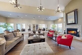 Located at 2705 Range Ave in Santa Rosa, California, the Vintage Ridge clubhouse is a single-story community facility offering a generous and thoughtfully designed gathering space. The welcoming entrance features tile flooring and glass double doors branded with the Vintage Ridge name, setting a polished tone from the moment of arrival.

The expansive great room is the centerpiece of the facility, boasting soaring vaulted ceilings adorned with multiple elegant chandeliers and recessed lighting. Large windows flood the space with abundant natural light, while rich hardwood flooring, a fireplace, and ample seating areas create a warm and inviting atmosphere. An adjacent lounge area with a round table and plush seating overlooks the outdoors through wide windows, offering a comfortable setting for smaller gatherings.

The fully equipped kitchen features rich dark wood cabinetry, granite countertops, stainless steel appliances, and hardwood floors — providing a functional and attractive space for community events. The dedicated fitness center is outfitted with a variety of cardio machines, free weights, cable equipment, and wall-to-wall mirrors. The laundry facility houses rows of commercial-grade front-load washers and dryers. The hallway connects all areas smoothly, and the outdoor grounds include a landscaped courtyard with a pool area, accessible through a gated entry.