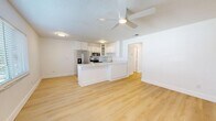 Located at 5009 S West Shore Blvd in Tampa, FL, this single-story 3-bedroom, 1-bathroom unit offers a clean, modern aesthetic throughout. The open-concept kitchen and living area serves as the heart of the home, featuring light wood-look flooring, crisp white walls, and a ceiling fan overhead. The kitchen is well-appointed with white shaker-style cabinetry, sparkling stone countertops, a peninsula with breakfast bar seating, and a full suite of stainless steel appliances including a side-by-side refrigerator with ice maker, electric range, over-the-range microwave, and a stainless undermount sink. The living area flows naturally from the kitchen, offering an open and airy feel. All three bedrooms continue the light wood flooring and bright white palette, with ceiling fans for added comfort. The spacious primary bedroom features two closets with built-in shelving, providing ample storage. The full bathroom includes a tub/shower combination with brushed nickel fixtures and a vanity with stone countertops. Additional features include a hallway connecting all rooms, a dedicated laundry area, and a textured ceiling throughout. The overall ambiance is bright, clean, and move-in ready.
