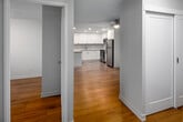 Located at 165 La Rose Ave, Suite 511 in Toronto's west end, this 2-bedroom, 1-kitchen, 1-living room unit offers a well-organized and efficiently designed layout across a single floor. Warm hardwood flooring runs throughout, lending a cohesive and inviting feel to the entire space.

The kitchen stands out as a clear highlight, featuring crisp white cabinetry extending to the ceiling for generous storage, a granite-topped peninsula ideal for casual dining or food prep, stainless steel appliances including a refrigerator, electric range, and microwave, and recessed lighting that brightens the space effectively.

A central hallway connects the living areas to both bedrooms, each equipped with sliding-door closets offering built-in shelving and hanging rods for organized storage. The spacious primary bedroom benefits from a large picture window framing views of the surrounding Toronto cityscape, filling the room with natural light.

The living room provides a clean, open canvas with neutral walls and hardwood floors, while the secondary bedroom offers a similarly bright and functional space. Throughout the unit, the design is clean and modern with a neutral palette, white trim, and consistent finishes that create a bright, move-in-ready atmosphere.