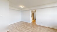 Located at 100 Dundas St E in Mississauga, Ontario, this 3-bedroom, 1-bathroom unit offers a well-designed layout across a single floor. The interior is finished with light wood laminate flooring and crisp white walls throughout, creating a clean and bright aesthetic in every room.

The living area is open and airy, connecting seamlessly to the kitchen, which features stainless steel appliances including a full-sized refrigerator. Large windows allow generous natural light to flow through the space, with select rooms offering elevated outdoor views of the surrounding Mississauga landscape, including tree-lined scenery. A balcony door in one of the main rooms provides direct access to the outdoors.

The primary bedroom is a comfortable size, featuring a wide window and baseboard heating. The two additional bedrooms are well-proportioned, each with their own windows that bring in ample daylight. All bedrooms share the same consistent light flooring and neutral white walls.

The bathroom is finished with classic white subway tile surrounding the bathtub and shower combo, complemented by chrome fixtures and a wall-mounted mirror, giving it a clean and timeless look. Overall, this unit offers a practical and functional living space in a well-positioned Mississauga location.
