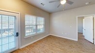 Located at 1881 SS Railroad Bed Rd in Statesboro, Georgia, this single-story home offers 2 bedrooms and 3 bathrooms across a thoughtfully designed floor plan. Wood-look flooring runs throughout the home, complemented by neutral-toned walls and clean white trim that create a bright, cohesive aesthetic.

The open-concept living room is spacious and airy, featuring a ceiling fan with light fixture and access to a exterior door that brings in natural light. It flows seamlessly into the kitchen, which is equipped with stainless steel appliances including a refrigerator, range, microwave, and dishwasher. White shaker-style cabinetry, granite-look countertops, and a subway tile backsplash complete the modern kitchen design.

The primary bedroom is generously sized with its own ceiling fan and connects to a walk-in closet outfitted with dual wire shelving systems on both sides. Each bedroom features large windows with blinds, allowing ample natural light and outdoor views. A stacked washer and dryer unit is conveniently integrated into the layout alongside one of the bathrooms, offering practical in-unit laundry. The home also includes an attached garage area with a concrete floor, visible in the floor plan. With three full bathrooms and a dedicated closet, this home provides excellent functionality and storage throughout.