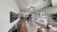 Located at 782 Oxbow Ave in Oswego, IL, this single-story, 2-bedroom, 2-bathroom residence offers a thoughtfully designed open-concept layout. The combined living room and kitchen area serves as the heart of the home, featuring rich hardwood-style flooring, neutral gray walls, and ceiling fans throughout. The kitchen is outfitted with dark cabinetry, granite countertops, stainless steel appliances, and a central island with bar seating, all illuminated by stylish pendant lighting. A dedicated dining area flows naturally from the kitchen, adding to the functional versatility of the space. The living room provides ample room for relaxing and entertaining, complete with a wall-mounted TV area and generous natural light. The primary bedroom is carpeted and well-sized, with large windows that invite natural light and a ceiling fan for added comfort. Both bathrooms feature dark vanity cabinetry, granite countertops, dual sinks, and a shower-tub combination. A dedicated in-unit laundry area accommodates a full-sized washer and dryer. Two closets and a hallway round out the floor plan, providing practical storage solutions throughout. The cohesive modern aesthetic and efficient layout make this a highly functional and inviting residence.
