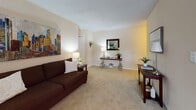 Located at 101 Hutson Dr in Summerville, South Carolina, this single-floor residence offers a well-organized layout with a variety of comfortable living spaces. The living area is carpeted and generously sized, featuring neutral walls that create a warm, inviting atmosphere. It accommodates both a sofa and armchair arrangement, with tasteful artwork adding a vibrant touch to the room. A console table with a mirror along one wall adds functional elegance to the space.

The bedroom is carpeted and benefits from natural light streaming through windows dressed with grommet-style curtains. A ceiling fan with a light fixture provides both comfort and illumination. An additional carpeted room, also with a ceiling fan and window, offers flexible use as a flex room, office, or sitting area, complete with a bookshelf and additional seating.

The kitchen features white cabinetry, granite-style countertops, a stainless steel sink, and wood-look flooring, giving it a clean, classic appearance. A dishwasher is also included. Adjacent to the kitchen, the dining area accommodates a round dining table with hardwood-style flooring and a bright window. The bathroom is finished with a shower/tub combination and vanity. Throughout, the space maintains a cohesive, neutral palette with comfortable finishes.