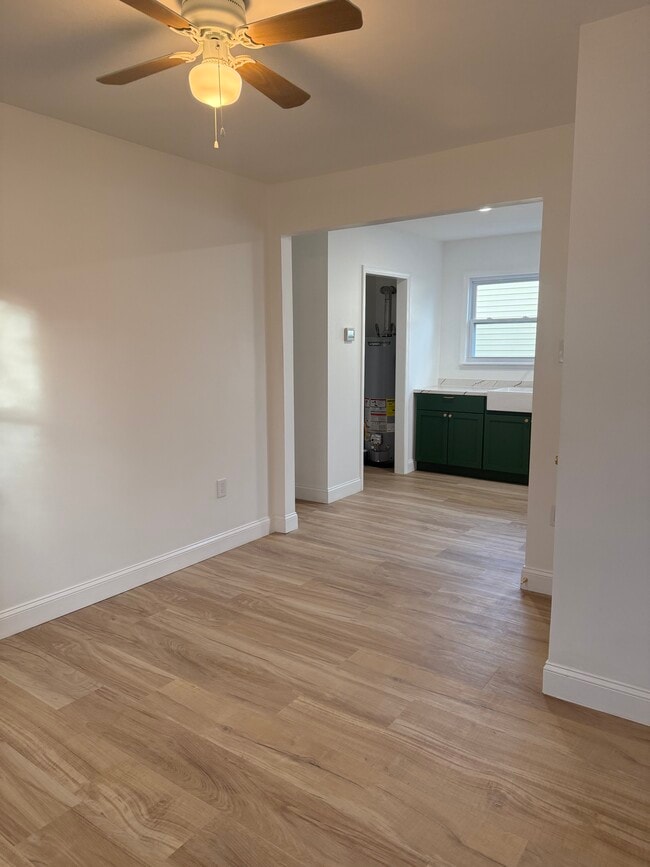 Sala de estar con vista a la cocina. El armario de servicio alberga la lavadora y la secadora, con espacio de almacenamiento. - 410 E Point Pleasant Ave