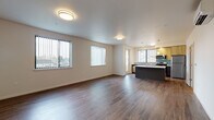 Located at 970 W 17th Ave in Junction City, Oregon, this contemporary two-floor residence offers a thoughtfully designed layout with modern finishes throughout. The open-concept main living area features rich hardwood-style flooring, neutral walls, and multiple windows dressed with vertical blinds that invite generous natural light. A wall-mounted mini-split unit provides efficient climate control.

The kitchen is a standout feature, centered around a large island with a sleek white countertop and dark cabinetry. It is outfitted with stainless steel appliances, including a refrigerator, range, and over-the-range microwave, complemented by warm wood-toned upper cabinets and a teal glass tile backsplash. Pendant lighting and ample counter space make this an ideal space for both cooking and entertaining.

The bedrooms are carpeted for comfort, each with windows that allow for natural light and outdoor views. The bathrooms maintain a clean, modern aesthetic with dark-toned vanity cabinetry, white countertops, and light wood-style flooring. One bathroom includes a soaking tub and shower combination with grab bars, while another features a sleek, minimalist design. The overall ambiance throughout is fresh, clean, and move-in ready.