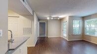 This 560 square foot one-bedroom apartment offers a thoughtful blend of comfort and functionality. The living room serves as the heart of the home, boasting a cozy fireplace and large windows that flood the space with natural light. Rich wood flooring extends throughout, creating a warm and inviting atmosphere.

The kitchen, while compact, is well-equipped with modern stainless steel appliances, light wood cabinetry, and a sleek backsplash. The bedroom, measuring 140 square feet, features plush carpeting and a sliding glass door leading to an outdoor area, perfect for enjoying morning coffee or evening relaxation.

The bathroom is efficiently designed with a single vanity and ample storage space. A closet provides additional storage solutions. The apartment's neutral color palette and textured walls create a canvas for personal style.

Notable features include track lighting in some areas, enhancing the modern feel, and the outdoor access which brings a touch of nature into the living space. This apartment in the Dominion Middle Ridge complex offers a perfect balance of comfort and practicality for single professionals or couples seeking a cozy urban dwelling.