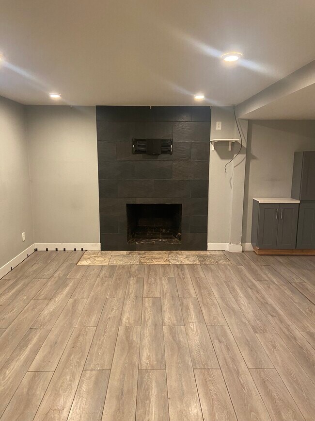 Living room- fireplace, TV mount, storage, & laminate flooring - 3901 N Kiska St