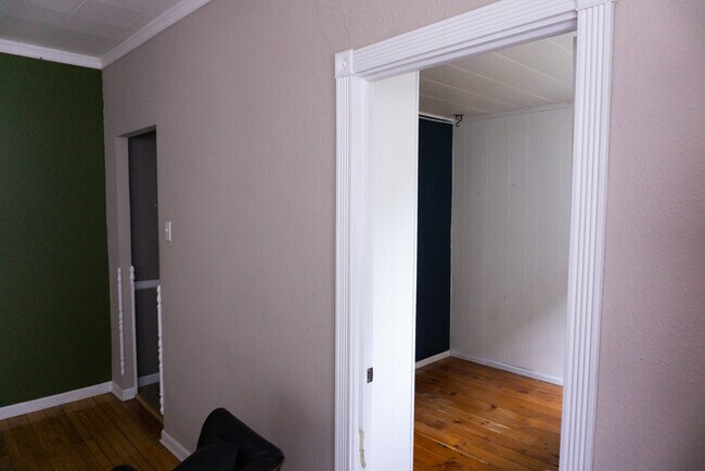 View into second bedroom and entrance to kitchen from dining/living space, facing north - 622 End Ct