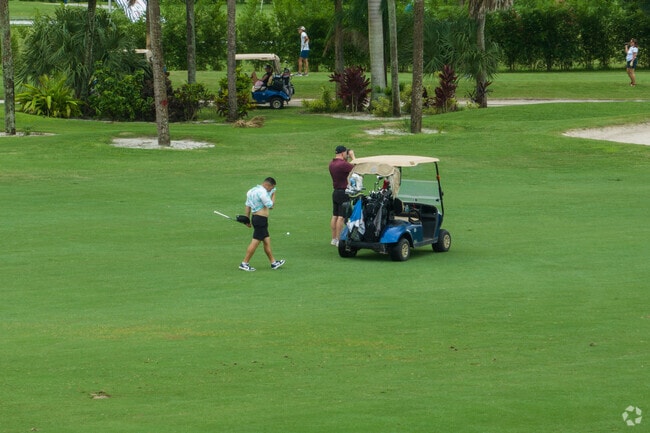 Golfers enjoying an afternoon at the Palm Beach National Golf Course.