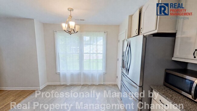 Building Photo - Charming home with open floor plan, vaulted ceilings and spacious backyard