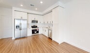 Located in Palmetto Bay, Florida, this two-story home offers 3 bedrooms, 3 bathrooms, and a well-organized layout spread across two floors. The ground floor houses a private garage equipped with an automatic opener and a water heater, along with utility and laundry areas. A staircase connects the lower level to the main living space above.

The upper floor serves as the primary living area and features a bright, modern kitchen outfitted with white shaker-style cabinetry, quartz countertops, a subway tile backsplash, stainless steel appliances including a refrigerator, range, microwave, and dishwasher, and wood-look vinyl plank flooring that flows throughout the space.

The three bedrooms are well-proportioned, with the spacious primary suite featuring an en-suite bathroom and ample natural light from multiple windows. The bathrooms are finished with neutral large-format tile, glass-enclosed showers, white vanities with quartz countertops, and modern chrome fixtures. One bathroom features a convenient half-bath configuration.

Throughout the home, clean white walls, recessed lighting, and wood-look flooring create a bright, cohesive aesthetic. Each bedroom includes a dedicated closet, and roller shades provide privacy and light control. The overall design is clean, contemporary, and move-in ready.