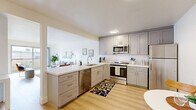Located at 544 Central Ave in Alameda, CA, this well-appointed one-bedroom, one-bathroom residence offers a thoughtfully designed single-floor layout. Light wood flooring runs through the main living areas, creating a warm and cohesive aesthetic throughout.

The kitchen is a standout feature, showcasing grey shaker-style cabinetry with ample storage, white quartz countertops, and a full suite of stainless steel appliances including a refrigerator, range, microwave, and dishwasher. A breakfast nook adjacent to the kitchen provides a convenient dining space with a bright, open feel.

The living room is bright and inviting, benefiting from large sliding glass doors that open to a private balcony with outdoor views — ideal for enjoying the Bay Area climate. The open layout between the kitchen and living area promotes easy flow and functionality.

The bedroom is a comfortable retreat featuring plush carpet, a mirrored sliding-door closet, and a window that allows in natural light. The full bathroom includes a tub-shower combination with a sliding glass enclosure.

Clean white walls, ample natural light, and a neutral palette give this residence a modern, move-in-ready ambiance suited for comfortable everyday living in the heart of Alameda.
