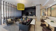 Located at 4700 Berwyn House Rd in College Park, Maryland, this single-floor amenity space delivers a striking blend of contemporary design and refined functionality. The layout encompasses several distinct yet interconnected areas, each thoughtfully curated to balance aesthetics with practicality.

The lounge area serves as a central gathering hub, anchored by a bold yellow sculptural pendant light that contrasts elegantly against dark accent walls and a built-in media wall. Plush curved seating in neutral tones, layered rugs, and eclectic accent chairs create an inviting and dynamic social environment. Vertical slat partitions define zones within the open plan without sacrificing flow or natural light.

A sunken lounge nook offers a more intimate setting, featuring a deep sectional sofa, teal area rug, and a mirrored ceiling detail with gold linear accents — adding a sense of drama and depth to the space.

The kitchen and catering area is outfitted with dark, high-gloss cabinetry, a double wall oven, open shelving, a sleek countertop workspace, and recessed lighting throughout. A peninsula with an integrated sink bridges the kitchen to the adjacent lounge, enhancing the open-concept feel.

The corridor connecting the zones features rich wood-tone flooring, stone-clad fireplace columns, shimmering chain curtain dividers, and glass-paneled doors that allow light to filter through. Expansive glazed doors open to an outdoor terrace, extending the space further and inviting abundant natural light.