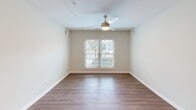 Located at 1901-1903 Florance St in Savannah, GA, this single-story, 3-bedroom, 2-bathroom home offers a clean, modern aesthetic with consistent wood-style flooring running throughout. The open-concept kitchen and living area serves as the heart of the home, featuring sleek gray cabinetry, white quartz countertops, stainless steel appliances including a refrigerator and range, and a double-basin sink. A peninsula provides additional prep space and flows naturally into the bright living room, which is highlighted by a ceiling fan, track lighting, and a window overlooking the outdoors. Each of the three bedrooms is well-sized with wood-style flooring, ceiling fans, and neutral wall tones. The primary bedroom includes access to a dedicated closet. Additional bedrooms feature ample space and access to a hallway with a louvered closet door. The two bathrooms are finished in a clean, contemporary style — one features a white vanity with brushed nickel hardware and a tub/shower combination, while the other includes a gray vanity with a lighted mirror. A connecting hallway ties all rooms together efficiently, completing this thoughtfully designed Savannah residence.