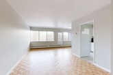 Located at 5500 Avenue Borden, Suite 510, in the residential neighbourhood of Côte-Saint-Luc, Québec, this well-laid-out one-bedroom, one-bathroom unit offers a comfortable and functional living environment. The space is unified throughout by warm-toned parquet wood flooring in a classic basket-weave pattern, lending a timeless character to every room.

The spacious living room is a standout feature, offering generous wall-to-wall windows that flood the area with natural light and provide views of the surrounding neighbourhood. Baseboard heating runs beneath the windows, ensuring year-round comfort. The open sightlines connect seamlessly to the entrance hallway, creating an airy and welcoming flow.

The kitchen is clean and efficient, featuring white cabinetry with gold-toned hardware, dark granite-style countertops, a white tile backsplash, and a full electric range with overhead ventilation. Tile flooring in the kitchen provides a practical contrast to the parquet found elsewhere.

The generously sized bedroom includes a dedicated closet and a window with an exterior view, offering a bright and restful retreat. The bathroom is finished in crisp white, complete with a full soaking tub and shower combo, white subway-style tile surround, a vanity with storage, and tile flooring. A hallway with additional closet space completes the unit's practical layout.