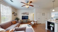 Located at 1605 Summerall Ln in Chesapeake, Virginia, this single-floor residence offers a well-designed layout with a comfortable and functional living environment. The open living room is a welcoming centerpiece, featuring rich hardwood-style flooring, a ceiling fan with light fixture, and large windows that invite an abundance of natural light. The space flows seamlessly toward the kitchen, which is appointed with dark cabinetry, granite countertops, a tile backsplash, and stainless steel appliances including a full-size refrigerator. The bedrooms are carpeted and bathed in natural light from generously sized windows with blinds and curtain panels, offering a calm and restful atmosphere. The bathrooms are finished with tile flooring, dark vanity cabinetry, and a full soaking tub with tile surround, providing a clean and polished look. A dedicated laundry area houses a full-size top-load washer and dryer along with overhead shelving for added storage convenience. Throughout the residence, the neutral color palette and consistent finishes create a cohesive and inviting ambiance well suited to everyday living in the Chesapeake area.
