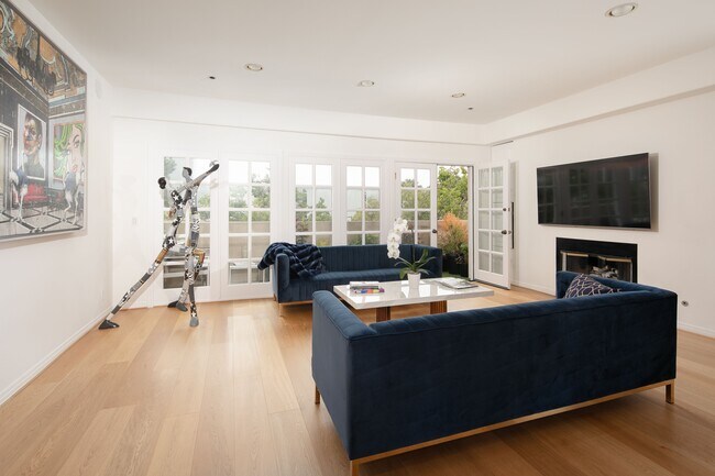 Living room area/ East facing balcony - 125 S Oakhurst Dr