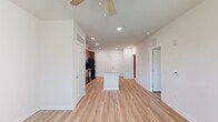 Located at 101 Madison Avenue in Athens, GA, this one-bedroom, one-bathroom unit offers a thoughtfully designed single-floor layout with a clean, modern aesthetic. Light wood-style flooring flows continuously throughout the space, complemented by crisp white walls and recessed lighting that create a bright, welcoming atmosphere.

The open-concept kitchen and living area form the heart of the unit. The kitchen is equipped with rich cherry-toned cabinetry extending to the ceiling for ample storage, black appliances including a gas range, built-in microwave, and refrigerator, as well as a granite-topped island that provides additional prep space and serves as a natural divider between the kitchen and the spacious living area. A ceiling fan keeps the living room comfortable and airy.

The bedroom is a well-proportioned retreat featuring a ceiling fan, natural light from multiple windows with blinds, and direct access to a dedicated closet. The bathroom is finished with large-format tile flooring, a rich wood vanity topped with granite, a wall-length mirror, and a full soaking tub with tile surround and brushed nickel fixtures. The overall design emphasizes functionality and clean finishes throughout every room.