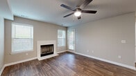 Located at 100 Arbor Lake Boulevard in Hermitage, TN, this one-bedroom, one-bathroom residence offers a thoughtfully designed single-floor layout. Rich wood-style flooring flows consistently throughout the space, creating a cohesive and warm aesthetic.

The main living area serves as the focal point of the home, featuring a classic white-surround fireplace, a ceiling fan with light fixture, and multiple windows that invite natural light. A private exterior door provides direct outdoor access. A secondary living area connects seamlessly to the kitchen, offering flexible space for dining or additional seating.

The galley-style kitchen is efficiently organized with white shaker cabinetry, light countertops, subway tile backsplash, and stainless steel appliances including a refrigerator, range, and microwave. Ample cabinet storage lines both sides of the kitchen corridor.

The bedroom is a comfortable, well-proportioned retreat with a ceiling fan, a window for natural light, and closet access. A sliding glass door in an adjoining area opens to views of the outdoors.

The bathroom is clean and functional, featuring a tiled tub-shower combination, white vanity cabinetry with a undermount sink, and wood-style flooring that ties the space together. A hallway and dedicated closet complete the practical layout of this residence.