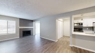 This 700 square foot apartment offers a thoughtfully designed living space with modern amenities. The single-story layout features one bedroom and one bathroom, ideal for individuals or couples. The open-concept design creates a seamless flow between the living areas, enhancing the sense of space.

The apartment boasts newly installed wood-look flooring throughout, providing a cohesive and contemporary aesthetic. The living room is a highlight, featuring a stylish fireplace with sleek grey tile surround, perfect for cozy evenings. Large windows and vertical blinds allow ample natural light, brightening the space.

The kitchen is efficiently designed with white cabinetry, contrasting grey subway tile backsplash, and stainless steel appliances. It opens to the living area, making it ideal for entertaining. The bedroom, measuring 150 square feet, offers a comfortable retreat with a walk-in closet for added storage.

The bathroom is well-appointed with a combination tub-shower, modern fixtures, and continues the apartment's neutral color scheme. Throughout the space, a palette of light grey walls and white trim creates a fresh, clean ambiance.

This apartment combines modern style with practical living, offering an updated and low-maintenance home in a compact footprint. Its location at 8850 River Bend Pky, Indianapolis, adds to its appeal for those seeking urban convenience.