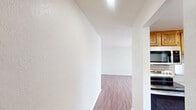 This well-designed apartment offers 1040 square feet of living space on a single floor, featuring three bedrooms and two bathrooms. The primary bedroom is generously sized at 170 square feet, providing ample space for relaxation. Throughout the apartment, warm wood flooring creates a cohesive and inviting atmosphere.

The modern kitchen is equipped with wooden cabinetry, stainless steel appliances, and ample counter space, making it functional for meal preparation. The living area is open and spacious, with large windows that allow natural light to flood the room, creating a bright and airy ambiance.

Both bathrooms are equipped with essential fixtures, including a shower with safety grab bars in at least one, demonstrating attention to accessibility. The apartment also includes a convenient in-unit laundry area.

Storage is well-considered, with closet space available in the bedrooms and throughout the apartment. The layout includes a hallway that connects the various rooms, ensuring a good flow throughout the space.

The neutral color palette of white walls and ceilings complements the wood flooring, allowing for easy personalization. This apartment, located in Summit West - 29F - C2, offers a comfortable and practical living environment suitable for a small family or shared living arrangement.