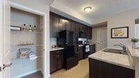 Located at 3785 Codet Rd. in Columbus, Ohio, this single-floor residence offers a thoughtfully designed layout with consistent, modern finishes throughout. The kitchen is a standout feature, showcasing rich dark espresso cabinetry that extends to the ceiling for ample storage, light granite countertops, black appliances including a refrigerator, range, microwave, and dishwasher, and durable light-toned hardwood-style flooring. A peninsula with a built-in sink adds both functionality and workspace to the kitchen.

The bedrooms are carpeted and finished in warm neutral tones, creating a calm and restful atmosphere. Natural light filters in through windows with views of the surrounding exterior. One bedroom features dual closets, providing generous storage, while another includes a walk-in closet area. Both rooms are well-proportioned and comfortable.

The bathrooms maintain the same design language as the rest of the home, featuring dark vanity cabinetry, granite-style countertops, and neutral travertine-style tile flooring. One bathroom includes a glass-enclosed shower, while another offers a combined tub and shower. Warm beige walls and ample lighting contribute to the clean, polished aesthetic found throughout this well-designed residence.