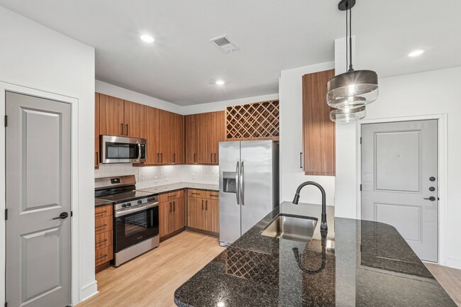 Kitchen with Granite Countertop and Stainless Steel Appliances. - Inkwell at Baseline